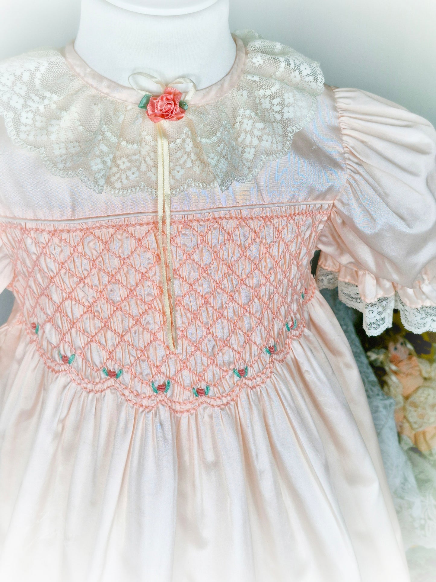 6-7 years. Peach Polly Flinders smock dress embroidered with flowers, with puff sleeves and lace collar