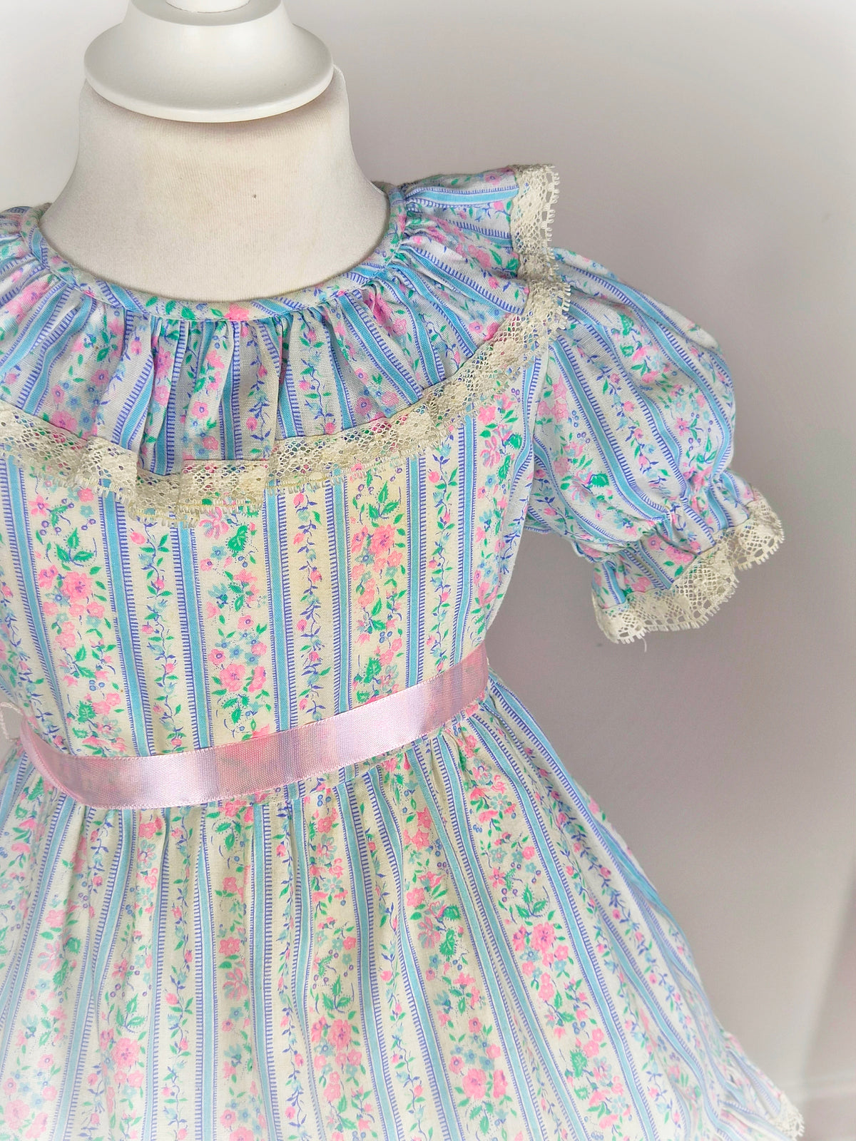 2 years. White vintage dress with blue stripes, pink flowers & belt and lace trim