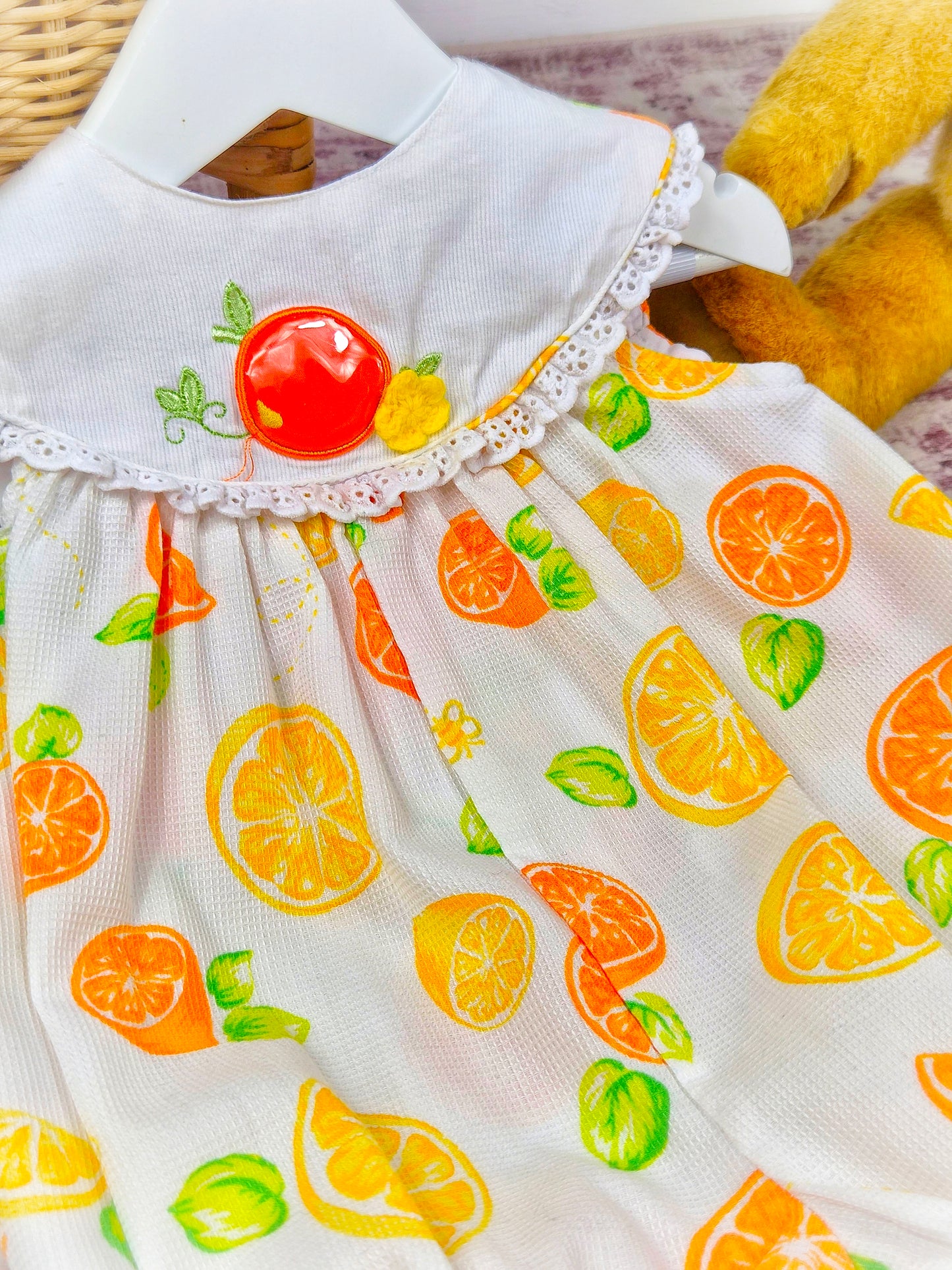 6-9 months. Sleeveless short vintage romper, white with oranges and lemons