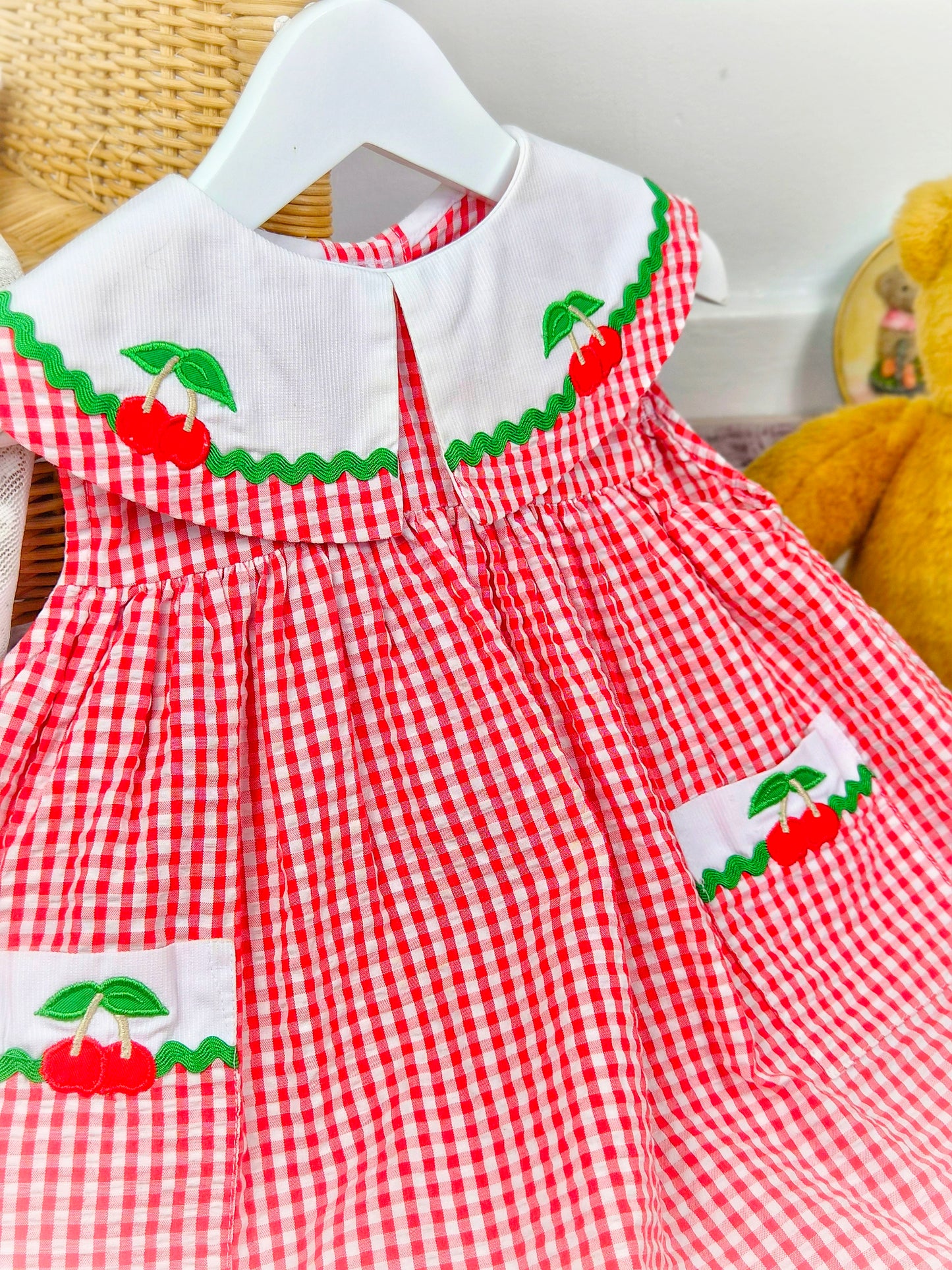 2 years. Red and white sleeveless vintage Samara dress with large collar and pockets adorned with cherries