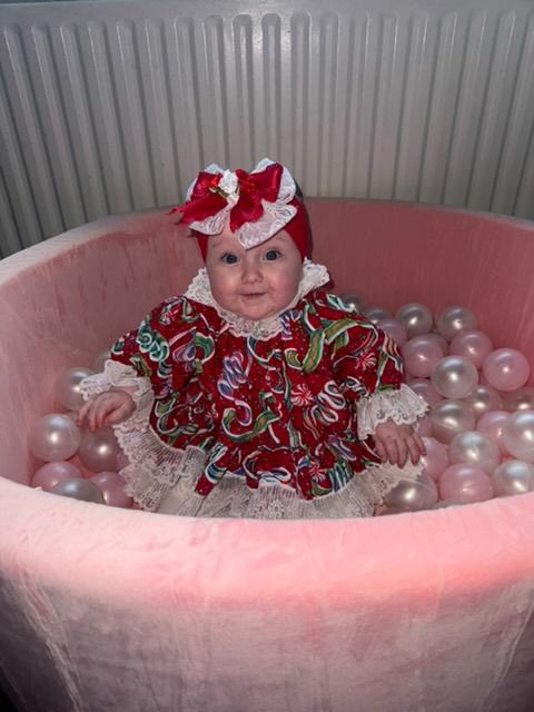 9-12 months. Brightly coloured handmade festive dress with puffed sleeves and a white lace trim
