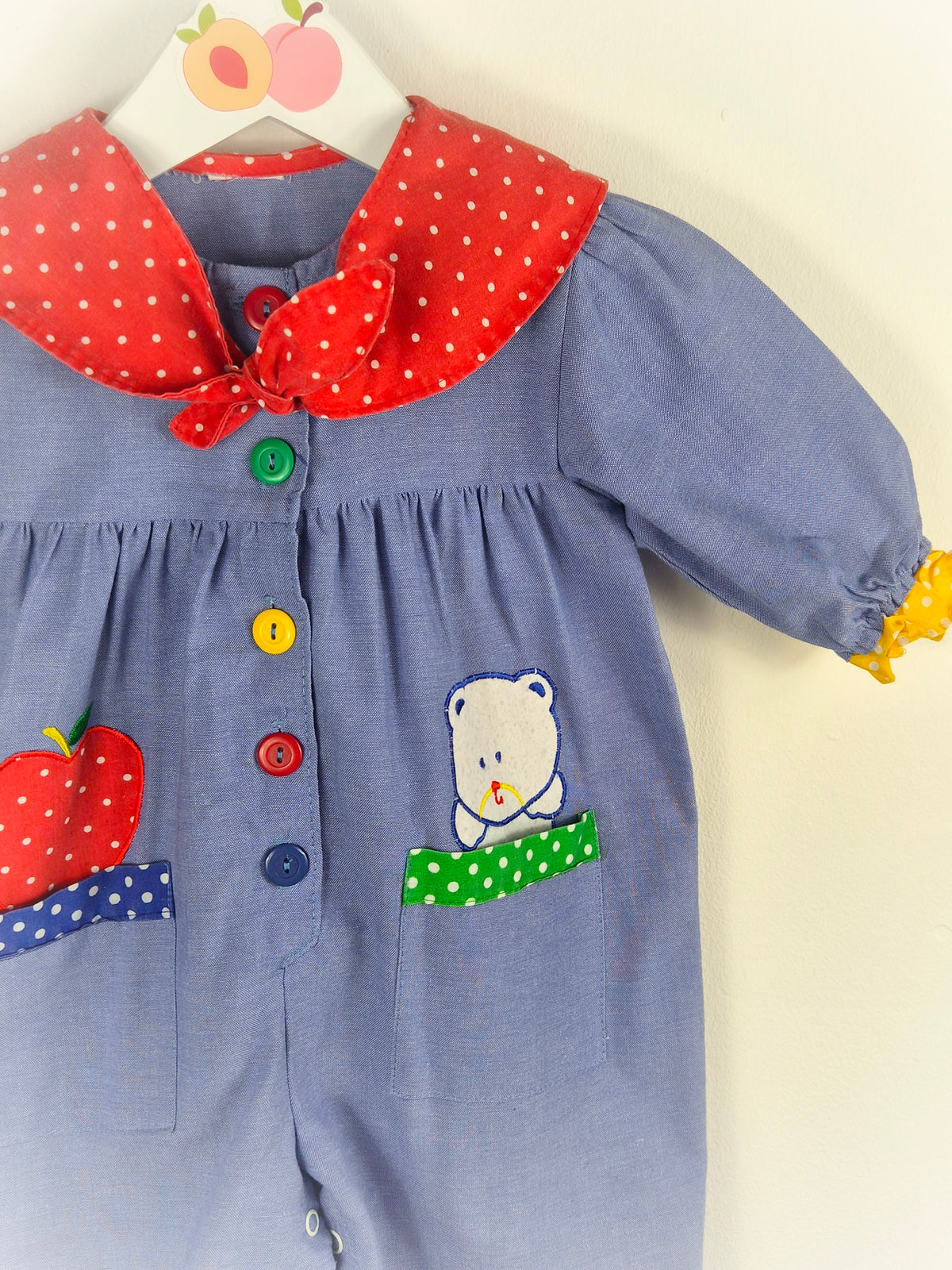 12 months. Vintage romper with red polka dot collar, primary coloured buttons & apple and teddy bear appliques