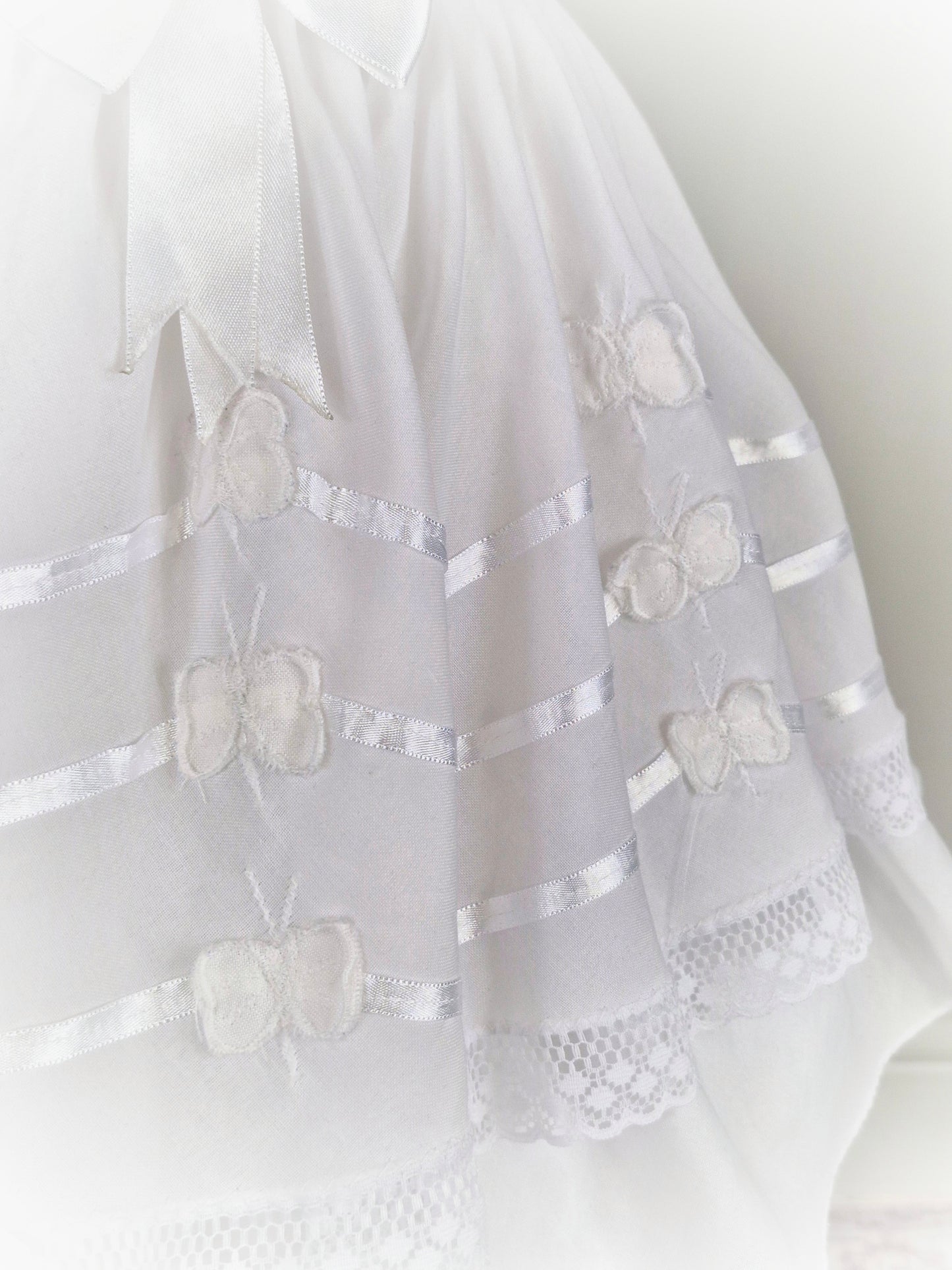 6 years. White dress with ribbon and butterfly details.