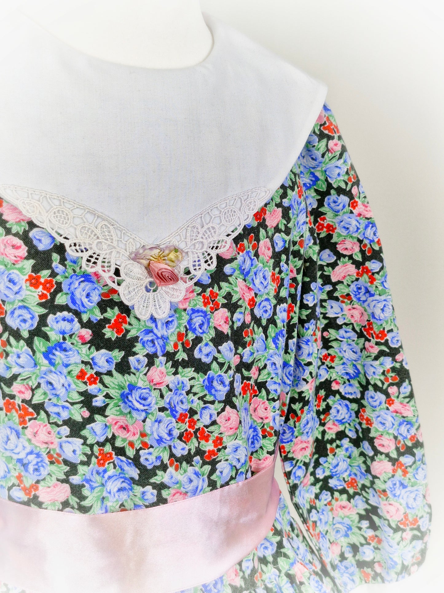 5 years. Black floral dress with white bib