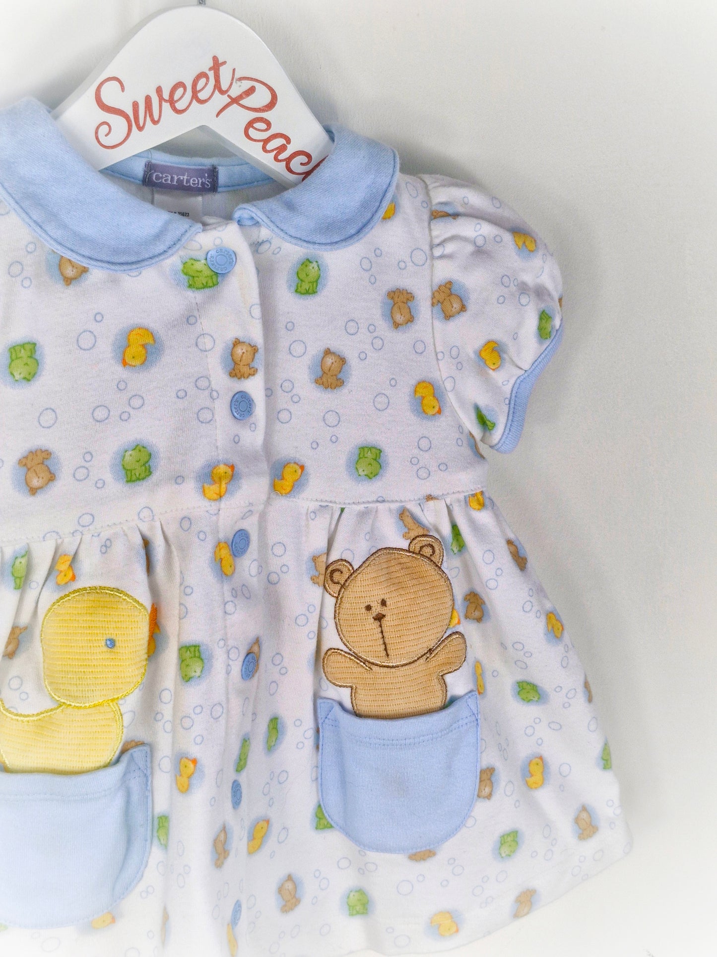 9-12 months. White vintage Carters dress with blue collar and pockets, bears, frogs and ducks print