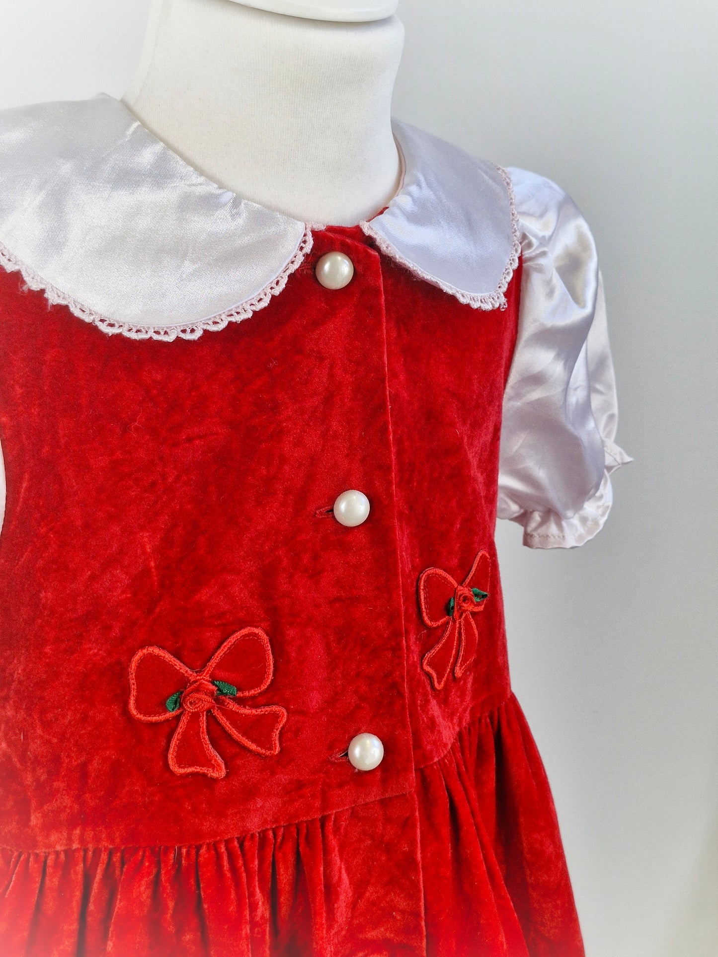 6 years. Red velvet dress with while silk collar and sleeves. Bow/Rose details, pearl buttons