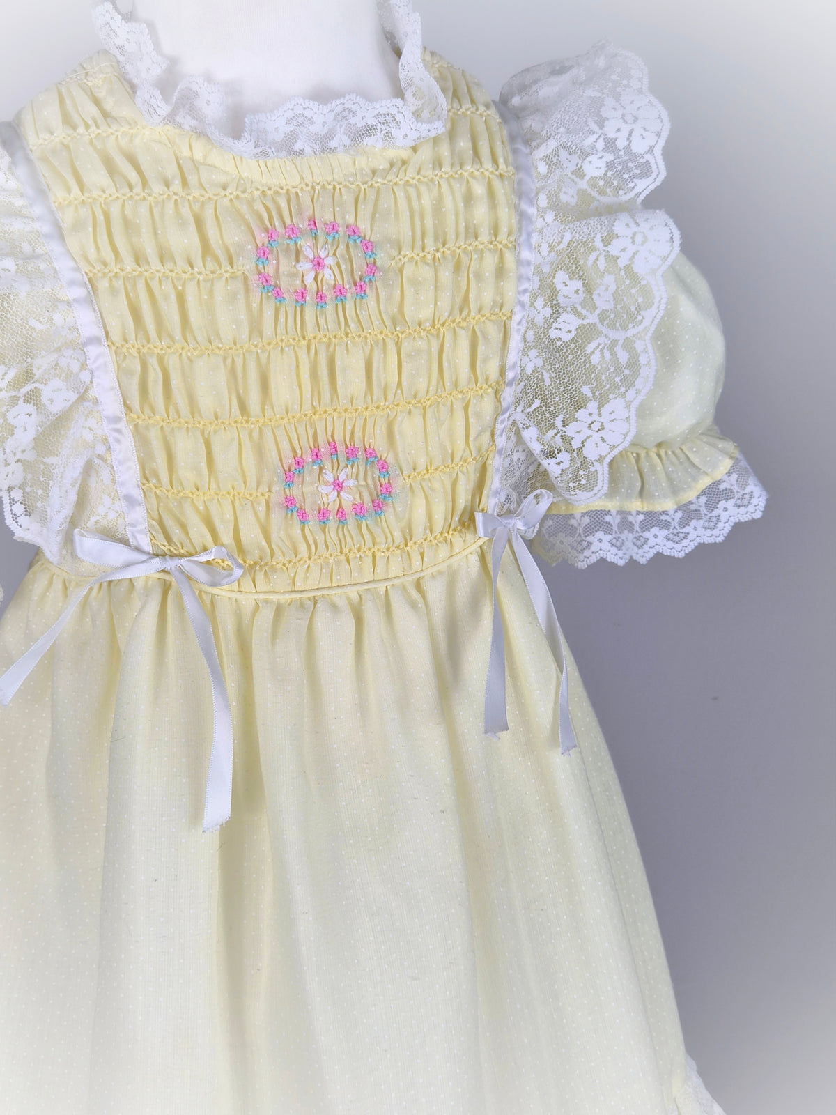 6-7 years. Lemon vintage smocked Polly Flinders dress with embroidered flowers, puff sleeves and lace trim