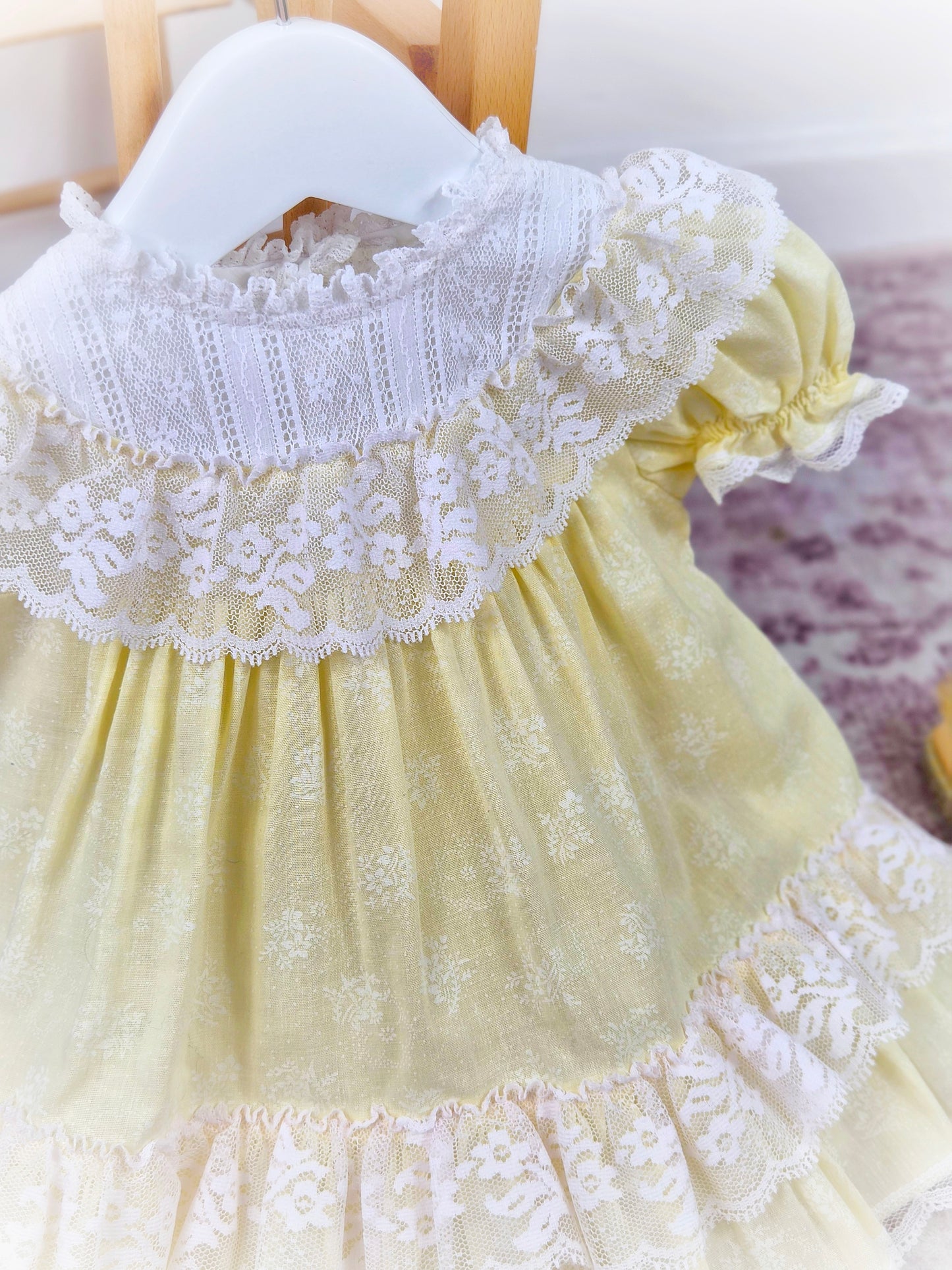 9-12 months. Lemon vintage Bryan dress with white lace bib, puff sleeves and frills