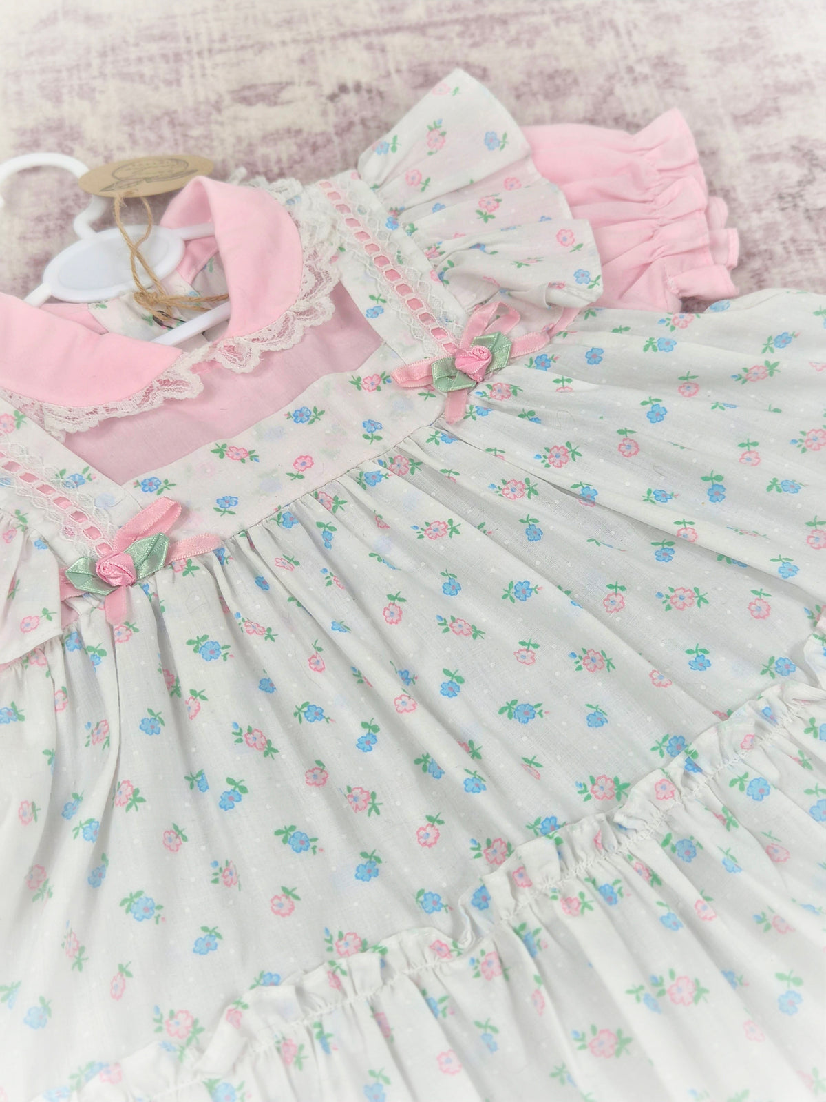 12-18 months. White vintage dress with floral design, frills, rosettes and satin bows