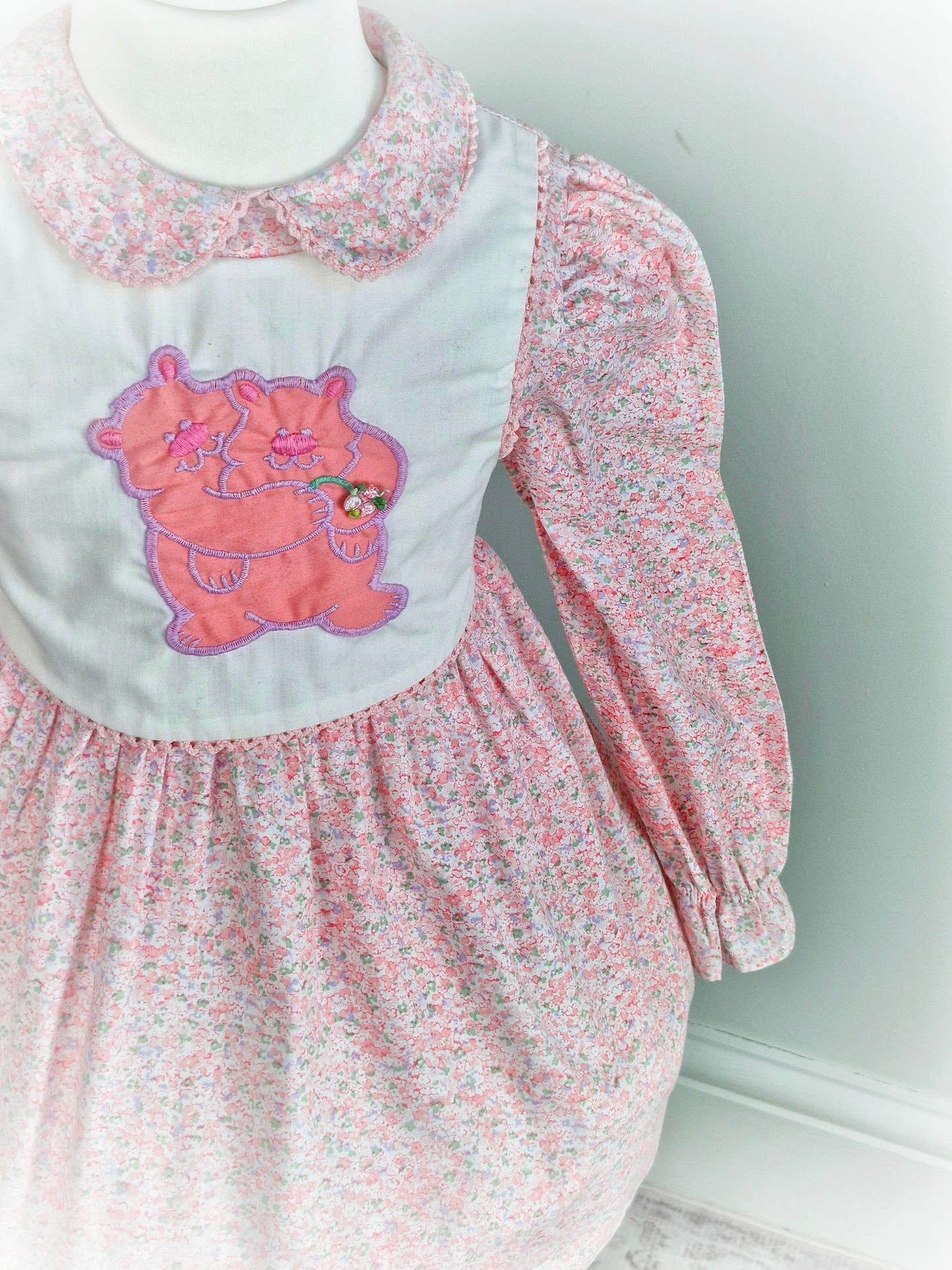 3 years. Pink floral vintage Polly Flinders dress with white bib featuring a bears applique