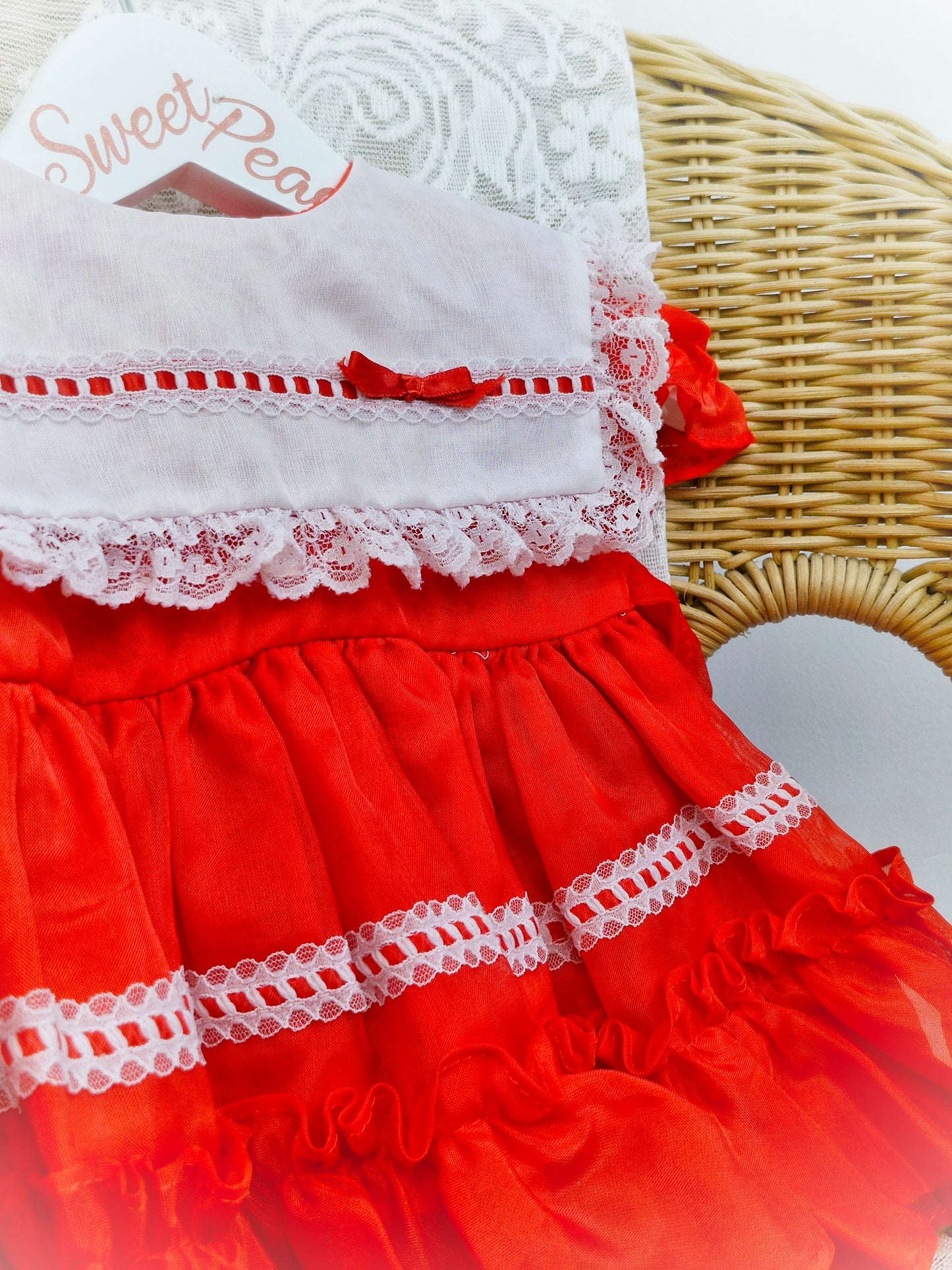 6-9 months. Red Kandy Ann dress with white bib and lace, red ribbon.