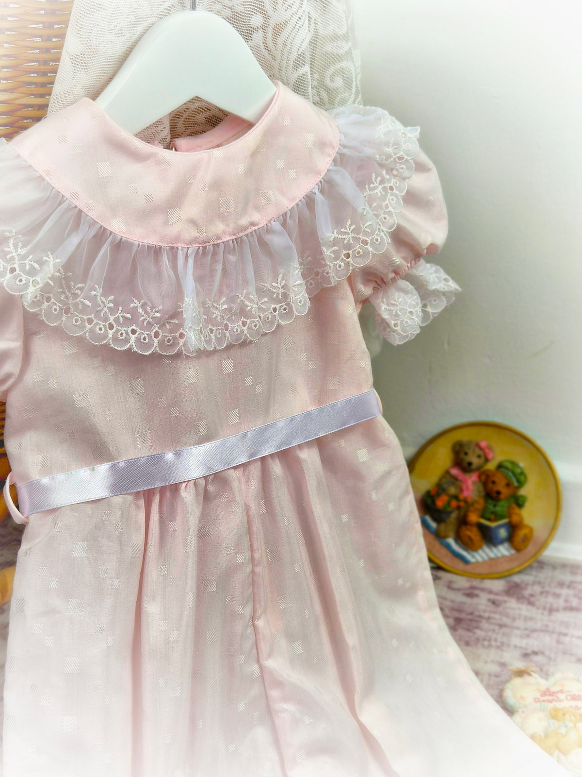 12-18 months. Pale pink vintage romper by I Am Erica with white lace bib trim and satin ribbon