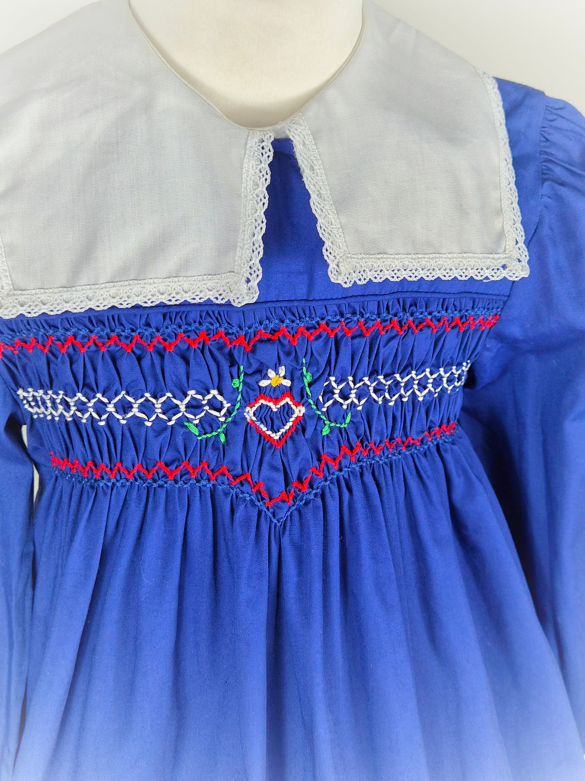 5-6 years. Royal blue vintage smock dress with embroidered heart and red design & white detachable collar. Princess Anne
