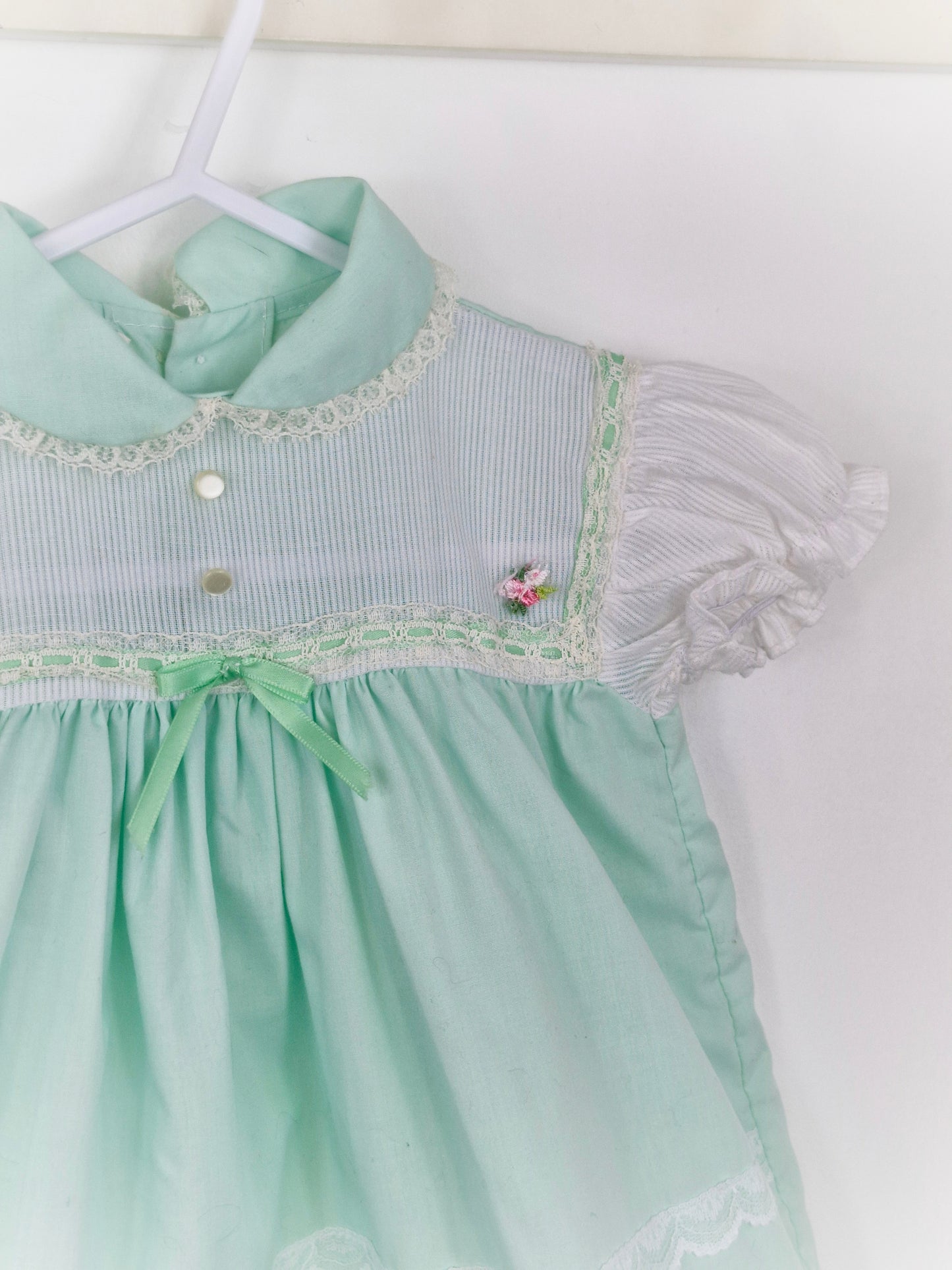12 months. Mint and white Cradle Togs with rosette, lace and ribbon details