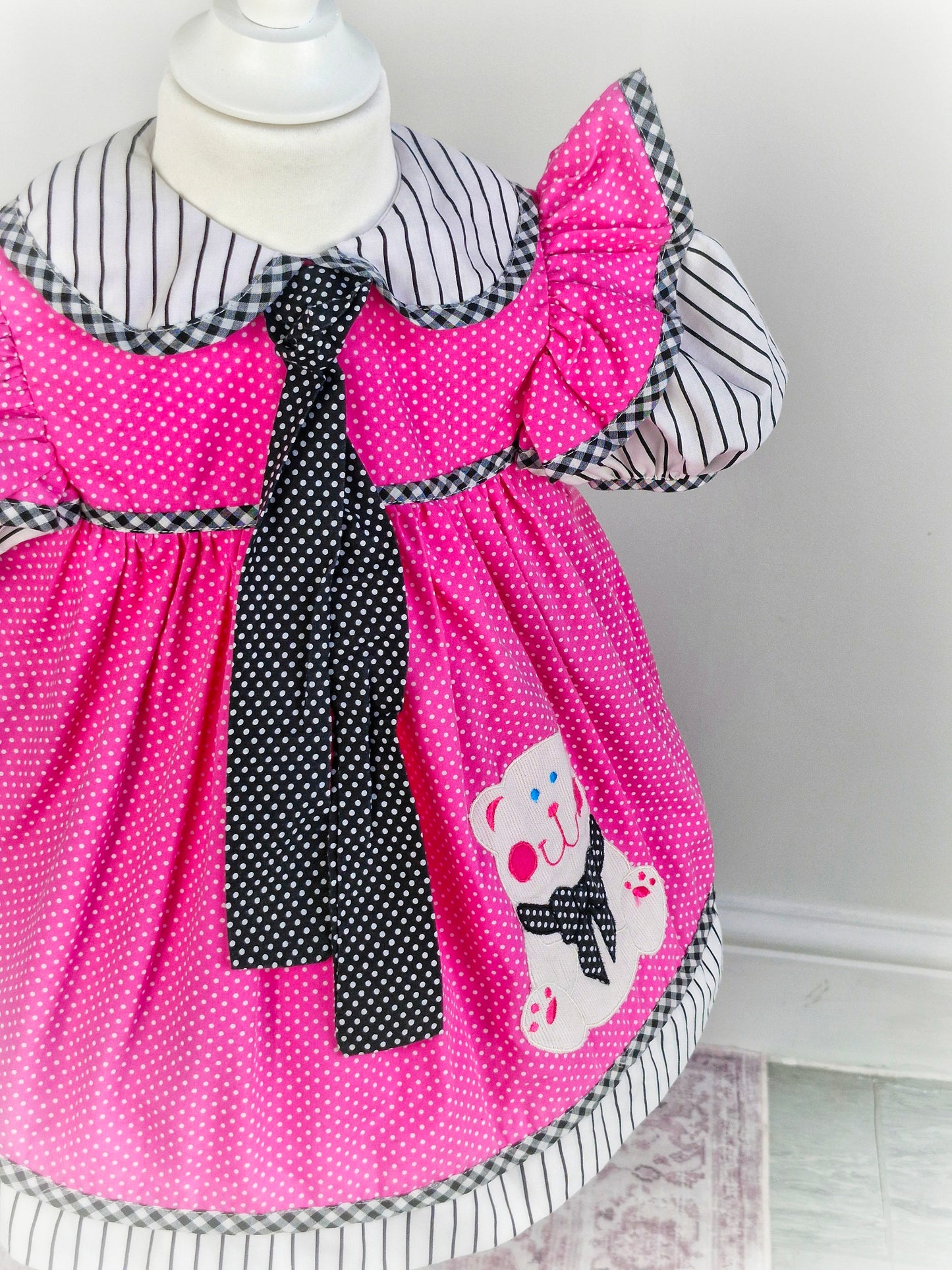 2 years. Pink, black and white vintage dress with bear applique and long neck tie