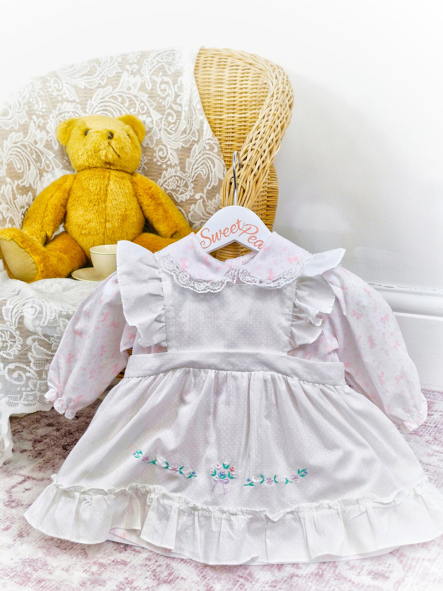 12-18 months. White dress with pink bows print and white pinny, embroidered with flowers
