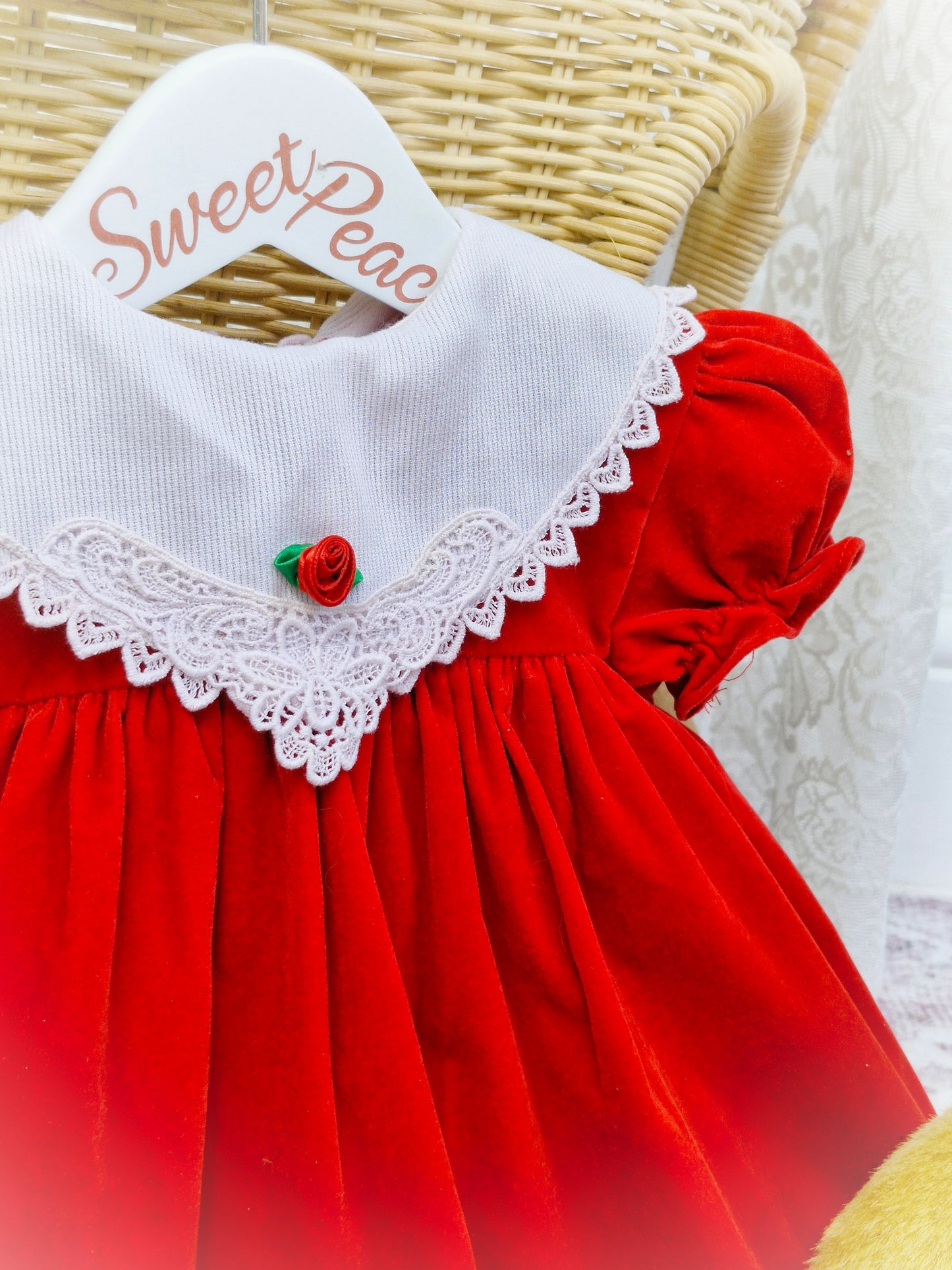 12-18 months. Red velvet dress with white bib and lace and a rosette. Hugs & Kisses