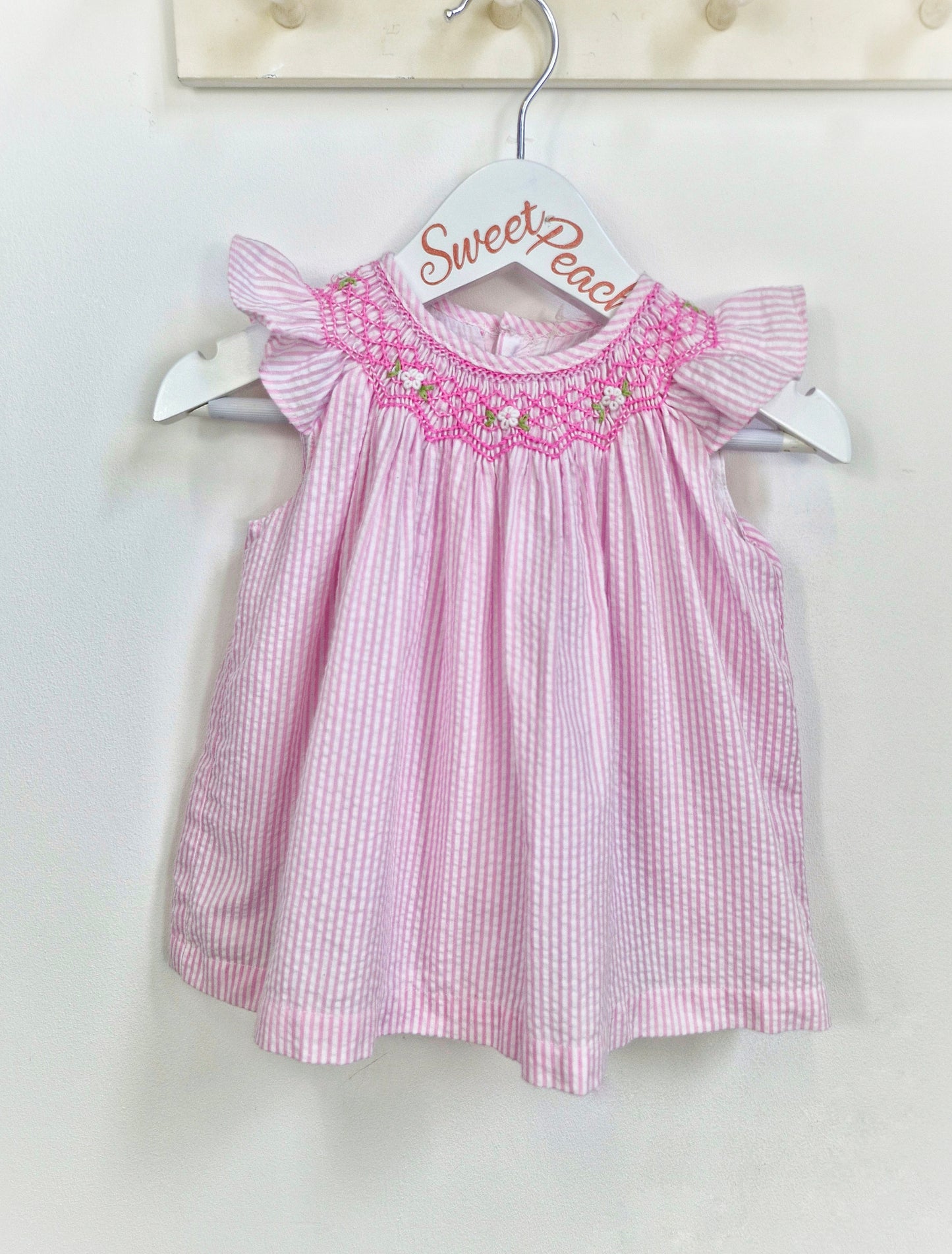 9-12 months. Vintage inspired pink and white striped dress with pink smock collar and flutter sleeves