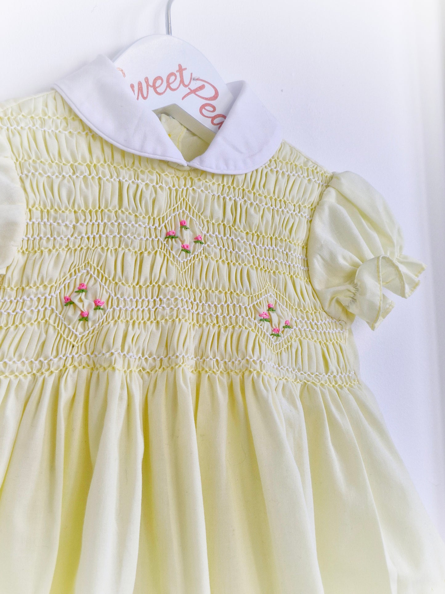 9-12 months. Lemon smock dress with pink embroidered flowers and white collar