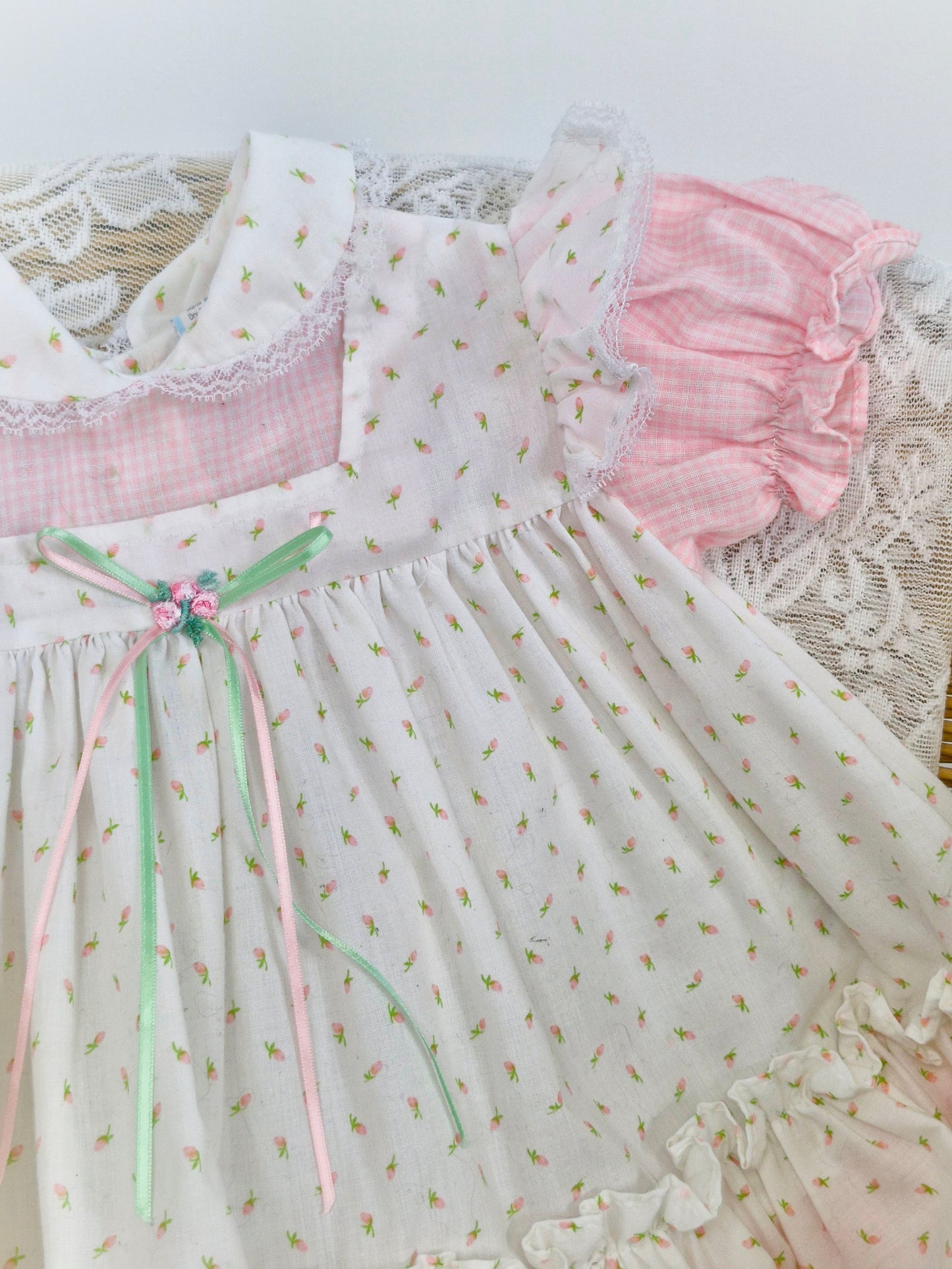 12-18 months two piece set, dress and bloomers. Pink and white gingham dress with apron with floral details.