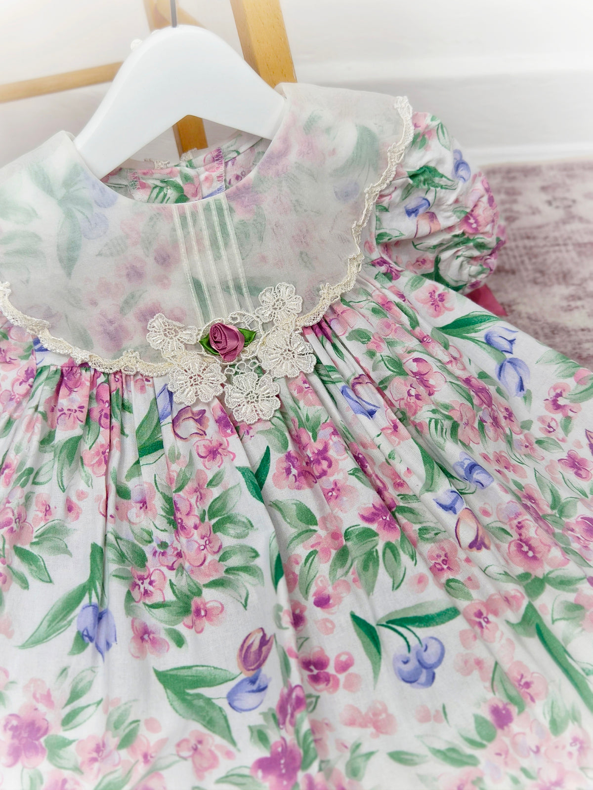 2 years. Floral vintage dress with white bib and pink sating ribbon bows