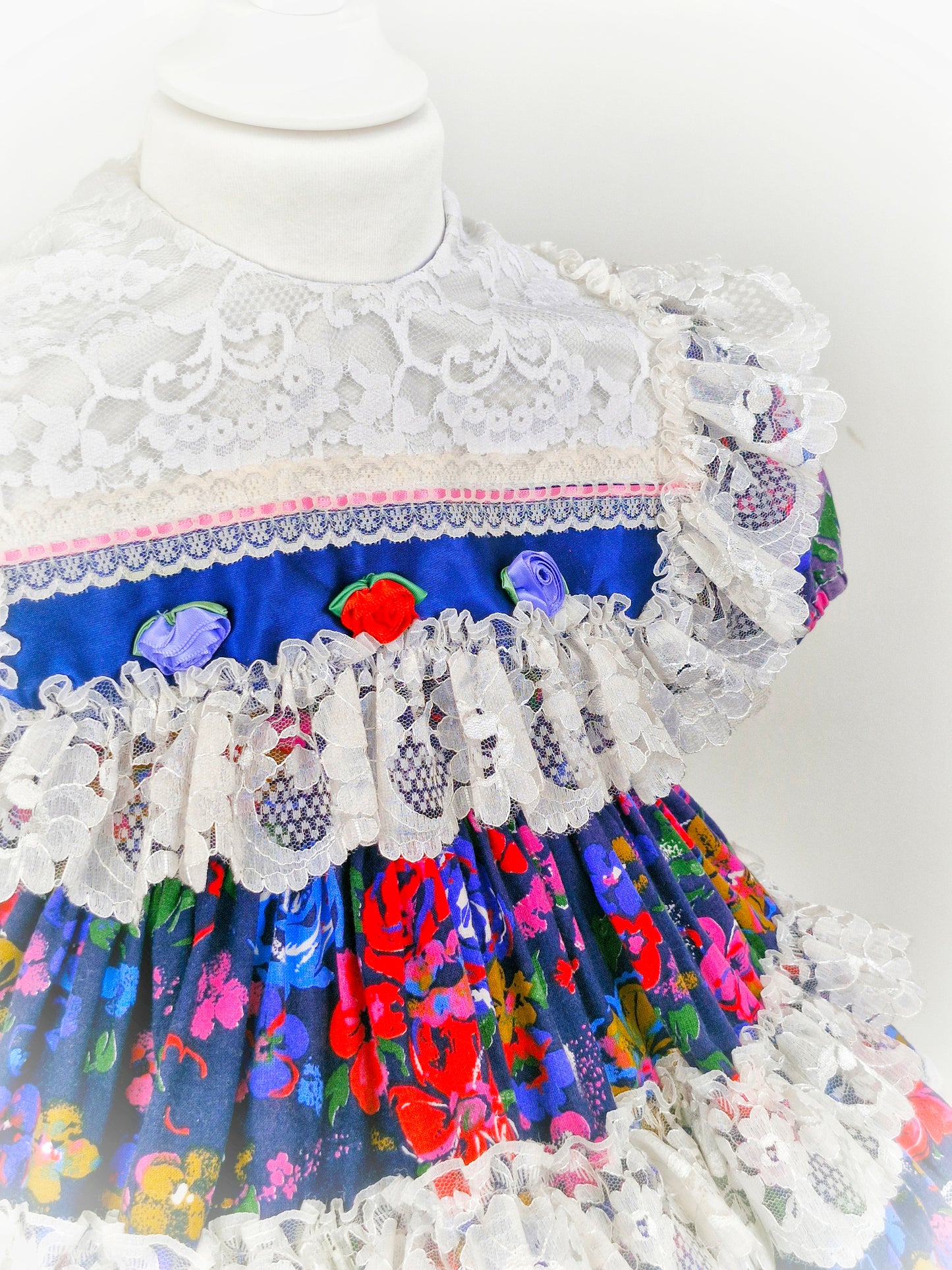 2-3 years. Kotton Kandi floral dress, navy with rosettes and lots of lace