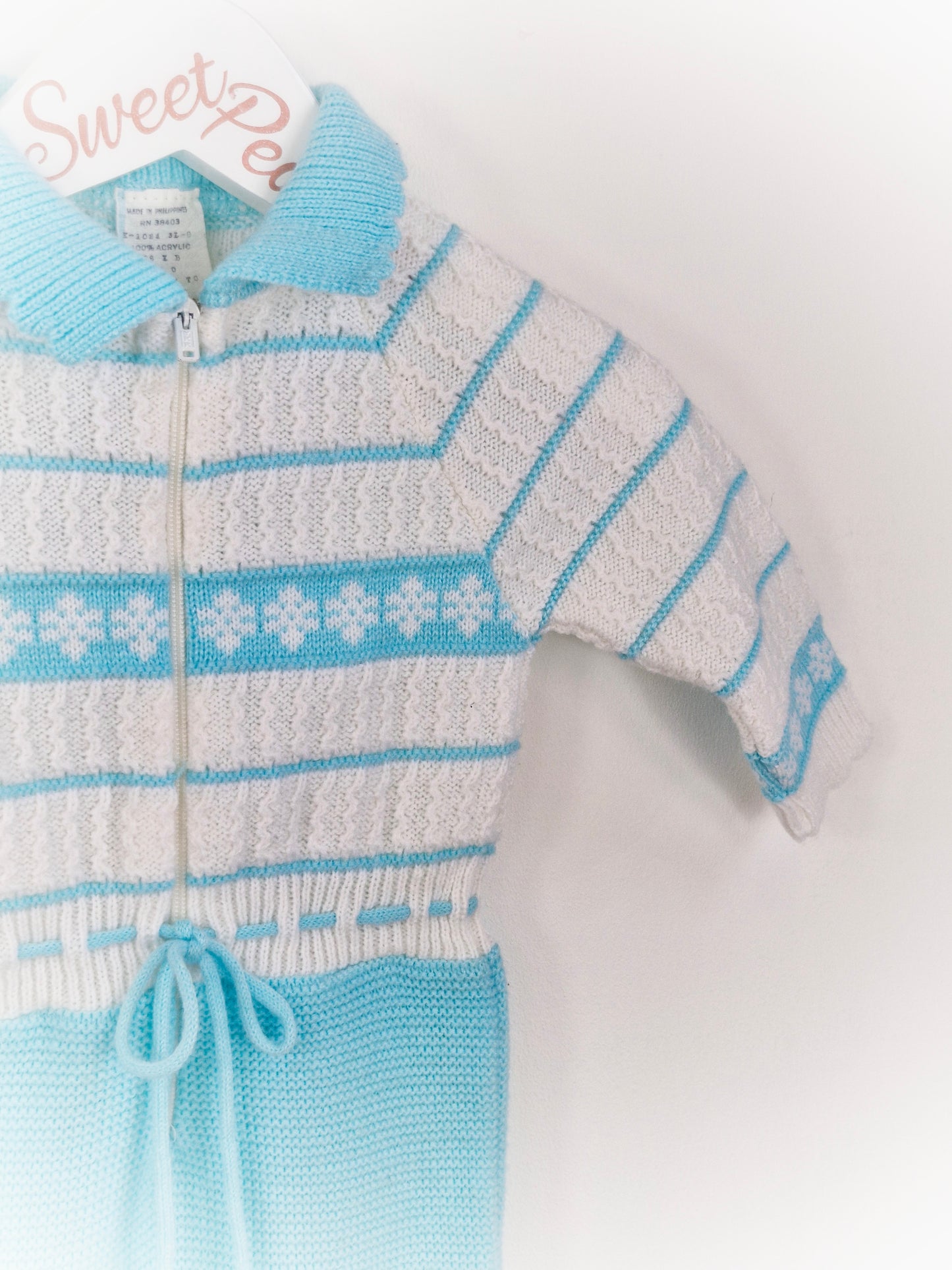 6-9 months. Blue and white knitted romper