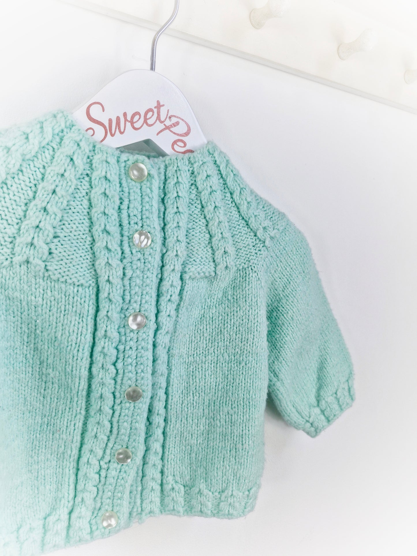 6-12 months. Hand knitted mint cardigan from the knitting needles of Audrey Seaton