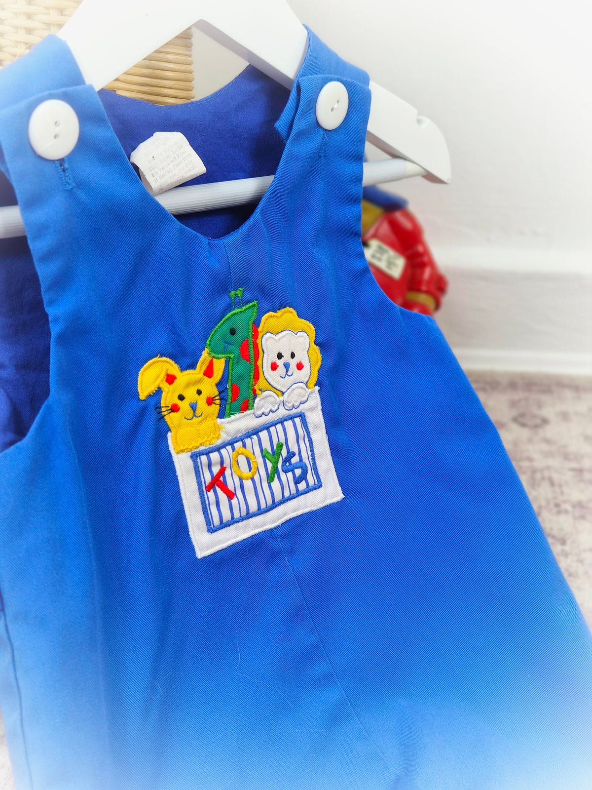 6-9 months. Royal blue romper with cute animals in a toy box