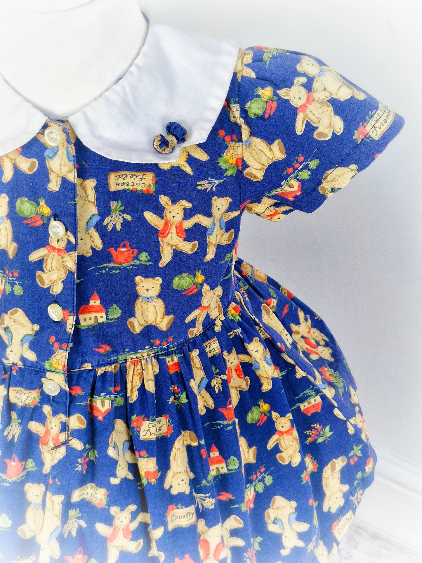2 years. Vintage inspired navy dress with Peter pan collar featuring teddy bears & bunnies