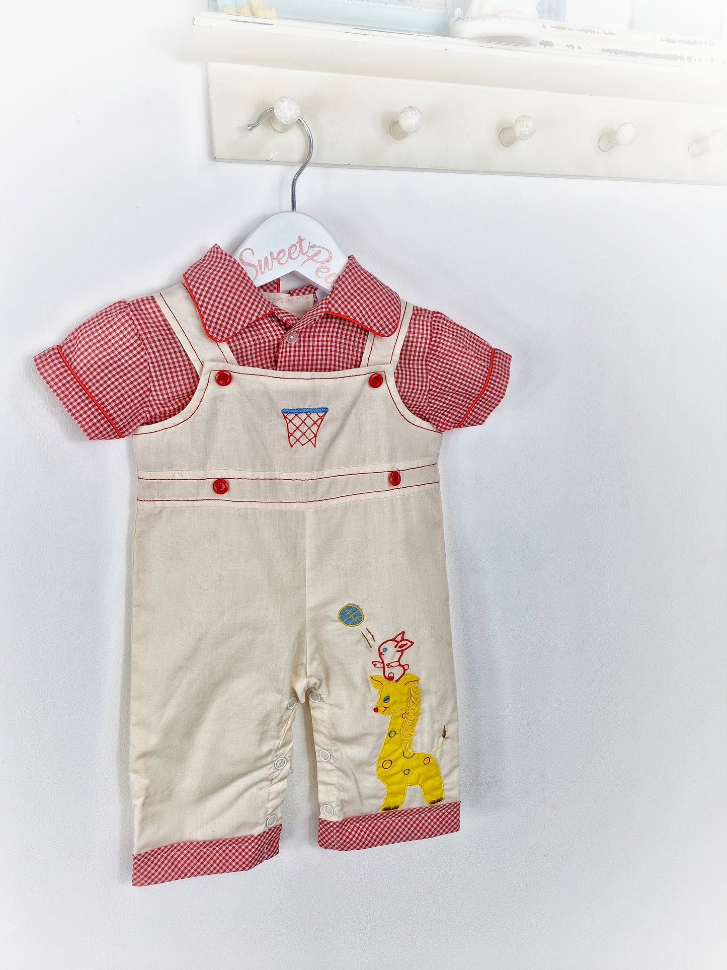 Best fit 6-9 months. Red and white checked romper with animals. Dungaree style