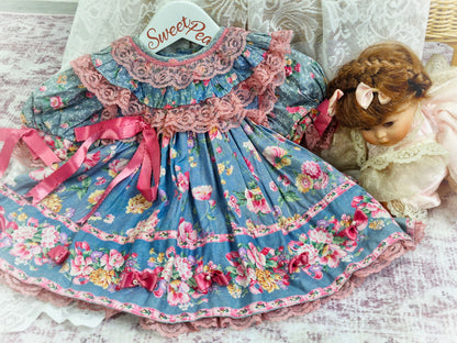 12 months. Blue dress with flowers. Pink lace and ribbons