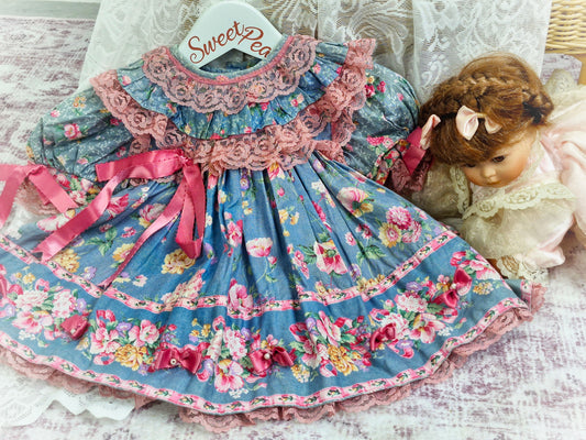 12 months. Blue dress with flowers. Pink lace and ribbons