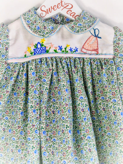9-12 months. Collared, floral dress with embroidered details