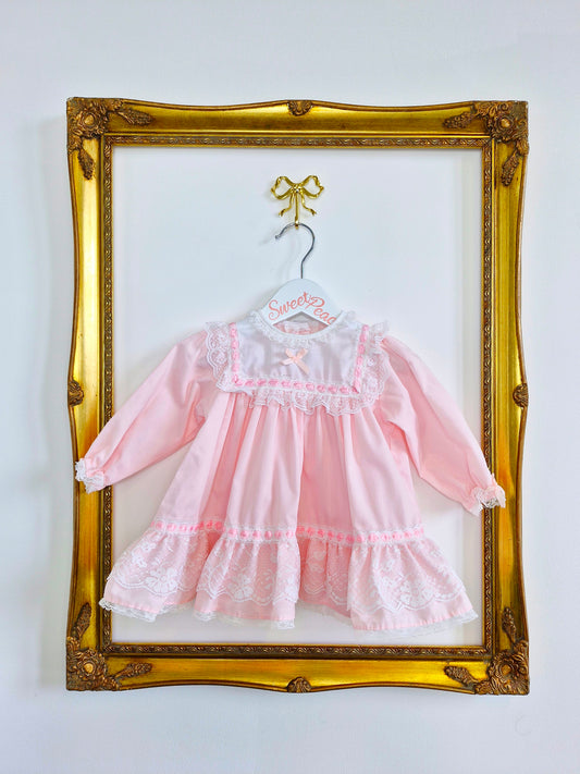 9-12 months. Pink Alexis dress with white bib, lace and ribbon details