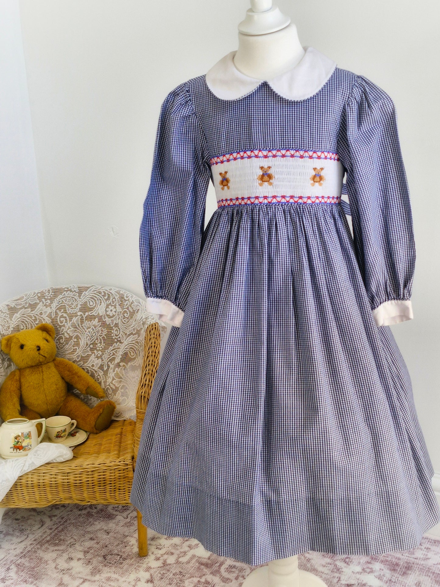 7 years. Navy and white Sweet Angela gingham smock dress with teddies