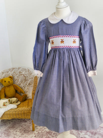 7 years. Navy and white Sweet Angela gingham smock dress with teddies