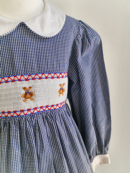 7 years. Navy and white Sweet Angela gingham smock dress with teddies