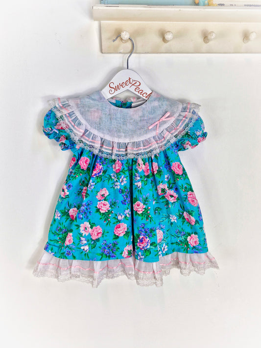 18-24 months. Floral dress from Carters with bib and ribbon details