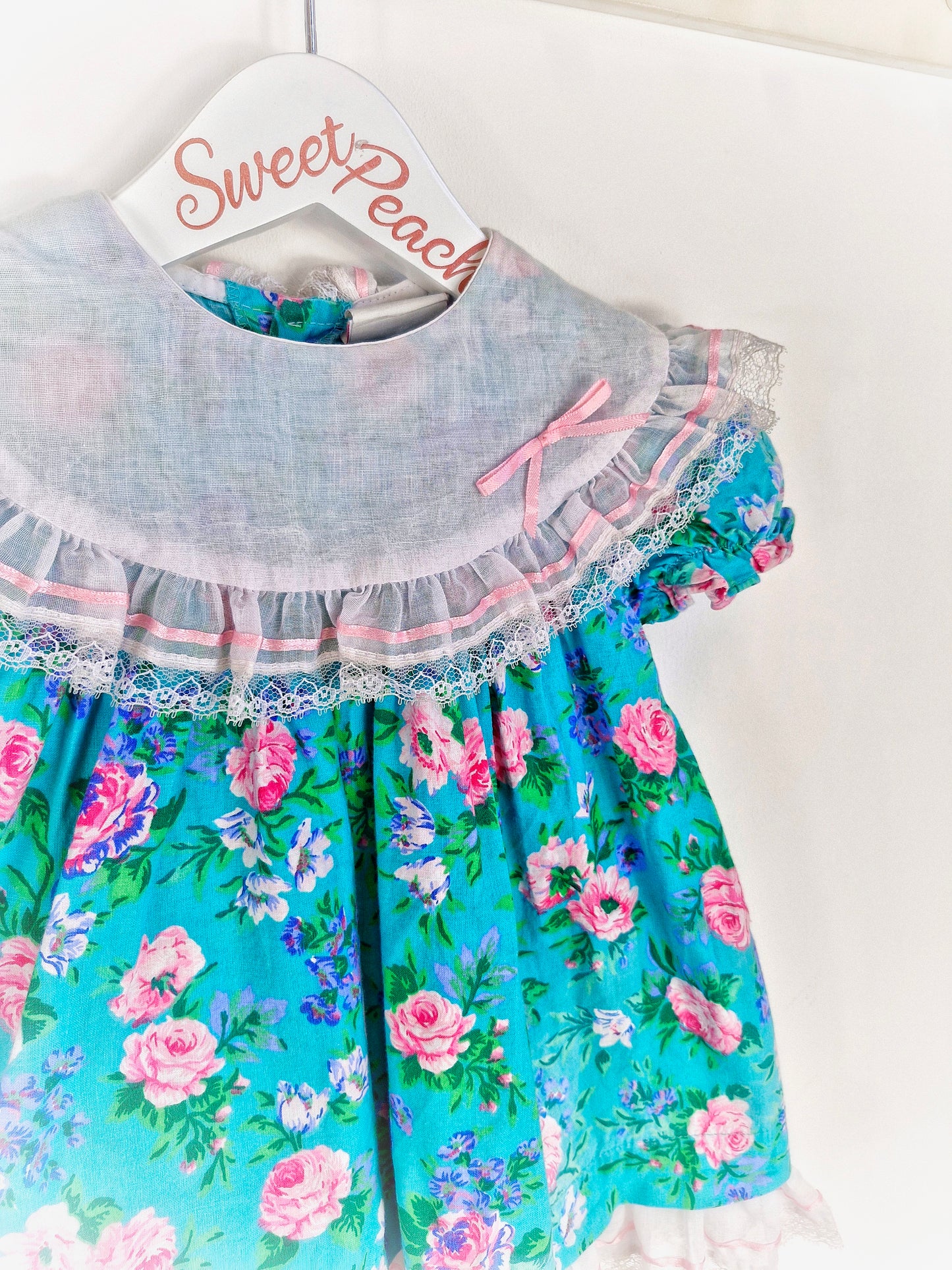 18-24 months. Floral dress from Carters with bib and ribbon details