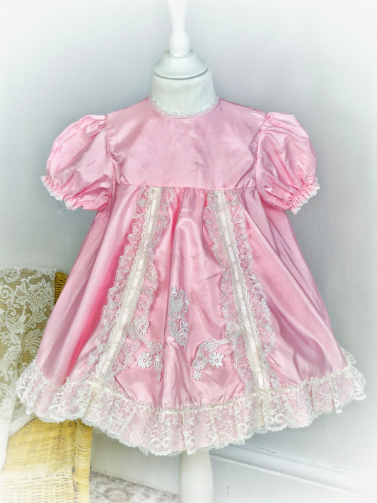 3 years. Pretty pink dress with white lace details