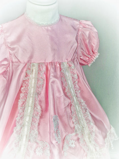 3 years. Pretty pink dress with white lace details