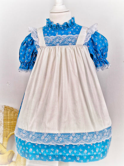 3-4 years. Blue floral Kawalla dress with attached white lace pinny