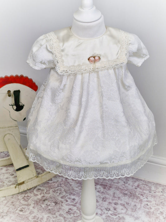 2 years. White Stone Gear dress with flowers, bib, lace and rosette. 1981.