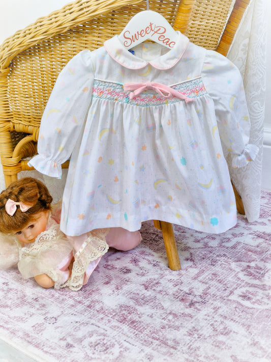 6-9 months. Polly Flinders 1962 smock dress, white with cute print
