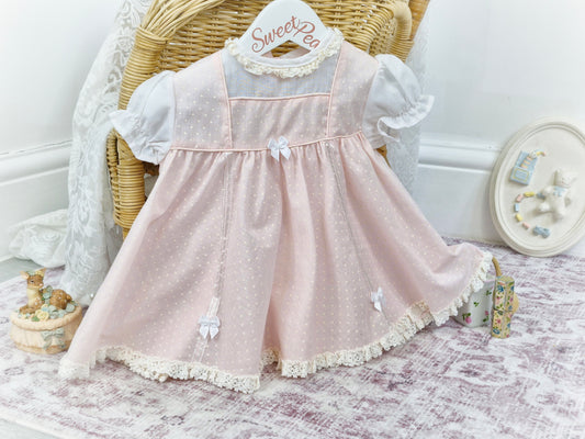 9-12 months. Pink and white polka dot dress with bows, 1960