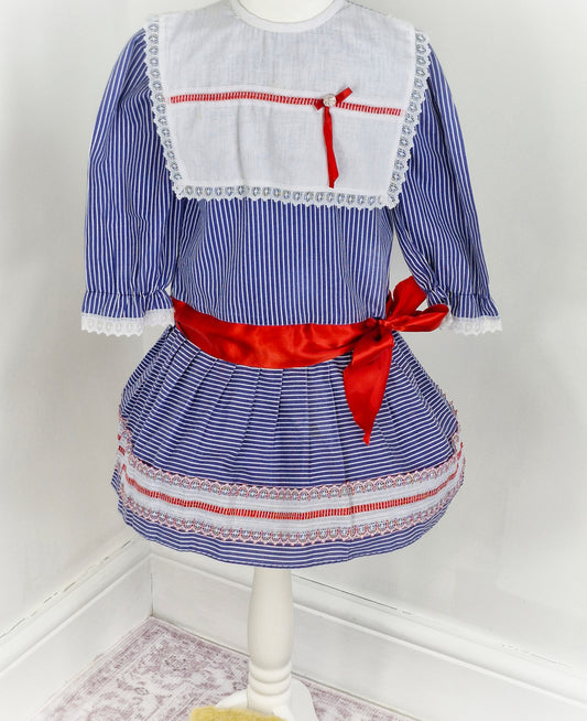 5 years. Blue and white striped vintage Mimix dress, long sleeve with white bib and red ribbon details