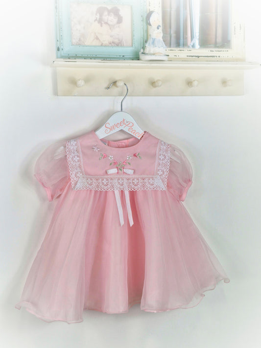 18-24 months. Pink Wildflowers by JC Penney. Lace trim on bib, embroidered with flowers