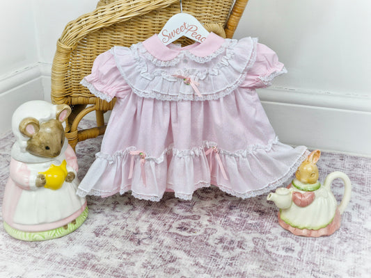6-9 months. Pink frilly Fayette dress with white, mock pinny