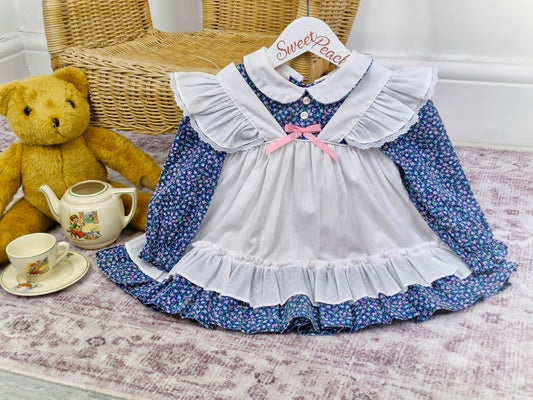 12-18 months. Navy long sleeve dress with floral print and white, mock pinny. New York Kids.